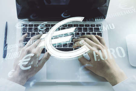 Creative EURO symbols sketch and hands typing on computer keyboard on background, strategy and forecast concept. Multiexposureの写真素材