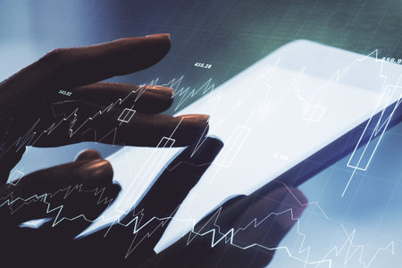 Double exposure of abstract creative financial diagram with finger clicks on a digital tablet on...