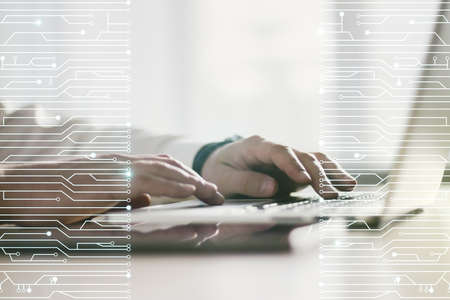 Double exposure of circuit hologram and hands typing on laptop on background. Research and development hardware conceptの写真素材