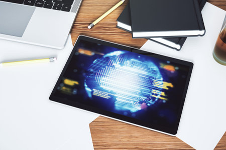 Modern digital tablet monitor with abstract programming language and world map, research and...