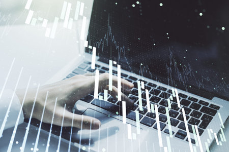 Multi exposure of abstract creative financial chart with hand typing on computer keyboard on...