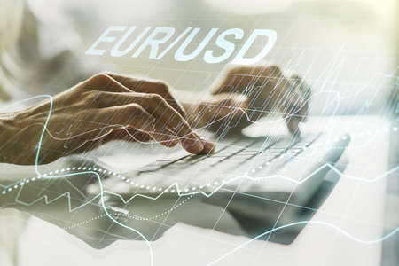 Creative EURO USD forex graph sketch and hands typing on computer keyboard on background, strategy and forecast concept. Multiexposureの写真素材