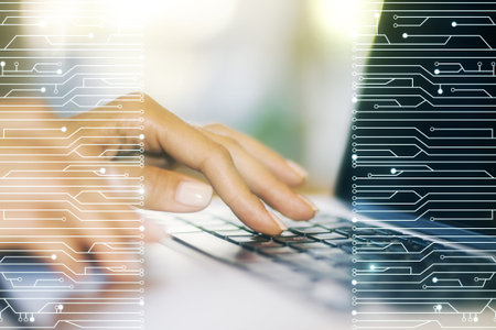 Double exposure of circuit hologram and hands typing on laptop on background. Research and...