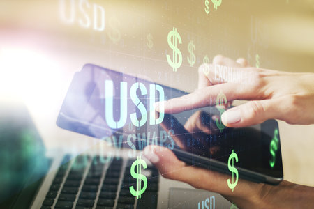 Creative concept of USD symbols illustration and finger clicks on a digital tablet on background. Trading and currency concept. Multiexposureの写真素材