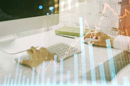 Multi exposure of abstract creative financial graph with hand typing on laptop on background, forex and investment conceptの写真素材