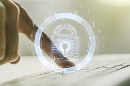 Creative idea concept with lock symbol and microcircuit illustration and hands typing on laptop on background. Protection and firewall concept. Multiexposureの写真素材
