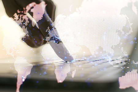 Multi exposure of abstract creative digital world map and hand typing on computer keyboard on background, research and analytics conceptの写真素材