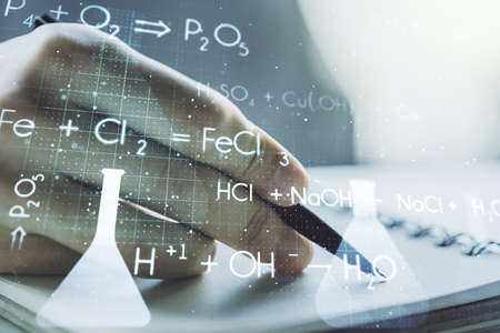 Double exposure of creative chemistry concept with man hand writing in notebook on background, research and development conceptの写真素材