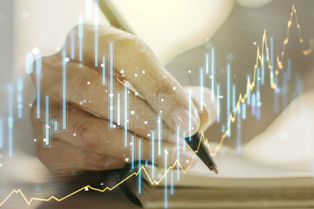 Multi exposure of abstract financial graph with hand writing in notebook on background, financial...