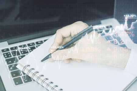 Abstract creative financial graph with hand writing in notebook on background, forex and investment concept. Multiexposureの写真素材
