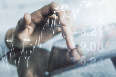 Double exposure of abstract creative financial diagram with finger clicks on a digital tablet on...