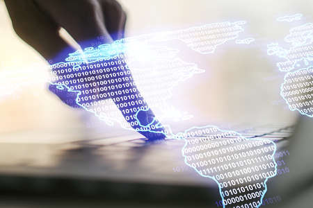 Double exposure of graphic America map and hand typing on computer keyboard on background, big data and digital technology conceptの写真素材