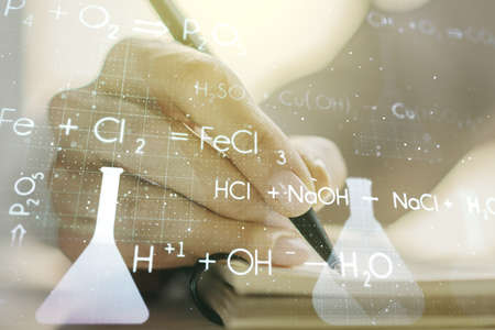 Creative chemistry illustration with woman hand writing in diary on background, science and research concept. Multiexposureの写真素材