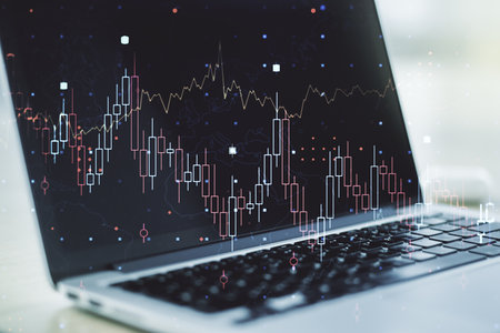 Abstract creative financial graph on modern laptop background, financial and trading concept. Multiexposureの写真素材