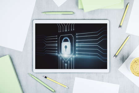 Top view of modern digital tablet monitor with creative lock hologram and chip. Information security concept. 3D Renderingの写真素材