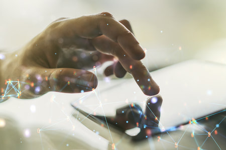 Double exposure of technology hologram and finger clicks on a digital tablet on background. Research and development software conceptの写真素材