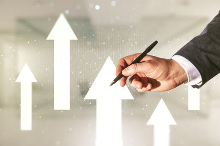 Man hand with pen draws abstract virtual upward arrows sketch on blurred office background, target and goal concept. Multiexposureの写真素材