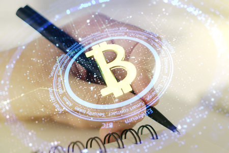 Creative Bitcoin concept with man hand writing in diary on background. Double exposureの写真素材