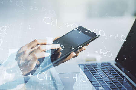 Creative chemistry illustration with finger presses on a digital tablet on background, science and research concept. Multiexposureの写真素材