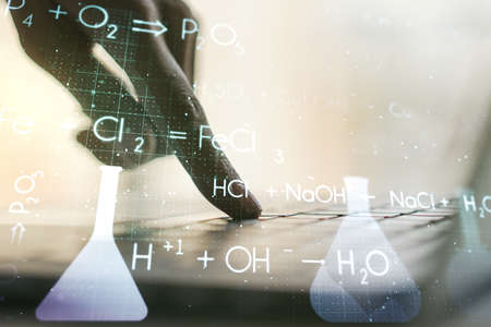 Creative chemistry hologram with hands typing on computer keyboard on background, pharmaceutical research concept. Multiexposureの写真素材