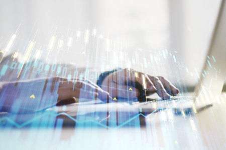 Double exposure of abstract creative financial diagram with hand typing on computer keyboard on...