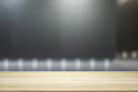 Blank wooden tabletop with empty space on modern shopping mall exterior background at night,...