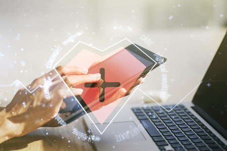 Creative abstract heart pulse hologram and finger presses on a digital tablet on background, online...