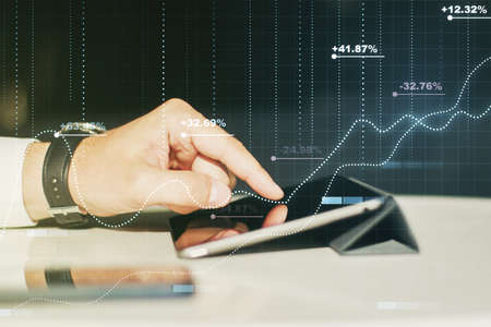 Abstract creative stats data concept with finger clicks on a digital tablet on background. Multiexposureの写真素材