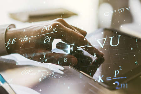 Creative scientific formula concept with finger clicks on a digital tablet on background. Multiexposureの写真素材