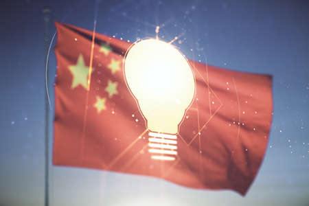 Abstract virtual light bulb illustration on Chinese flag and sunset sky background, future technology concept. Multiexposureの写真素材