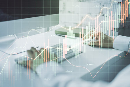 Double exposure of abstract creative financial chart with hand typing on computer keyboard on...
