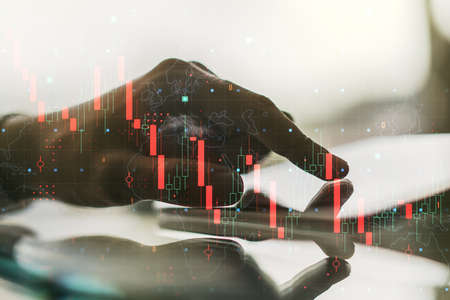 Creative abstract global crisis chart with world map sketch and hand working with a digital tablet on background, falling markets and collapse of global economy concept. Double exposureの写真素材