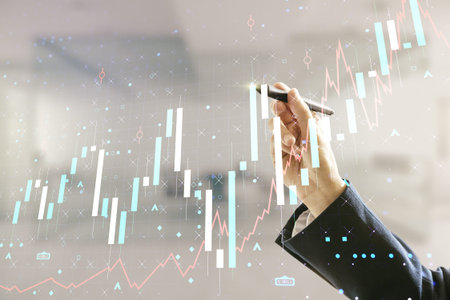 Man hand with pen working with abstract virtual financial graph on blurred office background,...