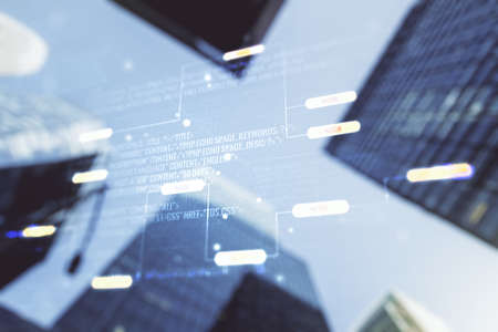 Double exposure of abstract programming language interface on modern skyscrapers background, research and development conceptの写真素材