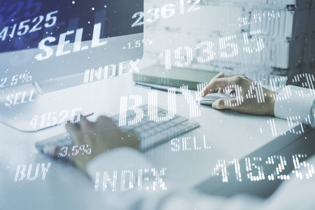 Abstract creative financial graph with hand typing on laptop on background, financial and trading...