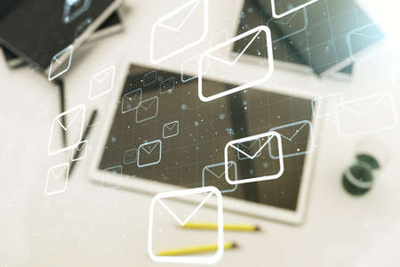 Creative abstract postal envelopes sketch and modern digital tablet on background, e-mail and marketing concept. Double exposureの写真素材
