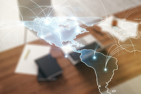 Double exposure of abstract digital world map with connections and modern desk with computer on...