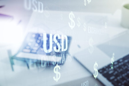 Double exposure of virtual USD symbols hologram on blurry calculator with laptop background. Banking...