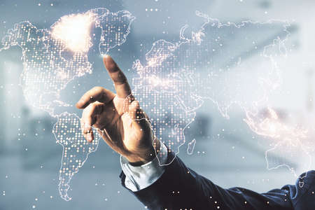 Multi exposure of man hand working with abstract graphic world map on blurred office background, connection and communication conceptの写真素材