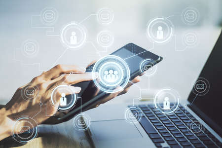 Double exposure of social network icons concept and hand working with a digital tablet on background. Networking conceptの写真素材