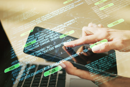 Multi exposure of abstract programming language hologram and hand working with a digital tablet on...