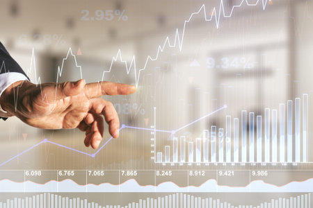 Man hand working with abstract virtual financial graph on blurred office background, forex and...