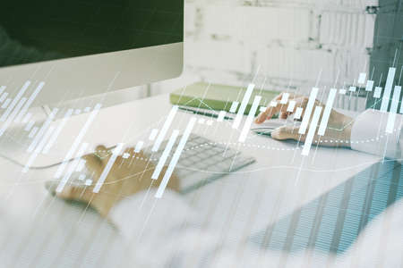 Double exposure of abstract creative financial chart with hand typing on computer keyboard on background, research and strategy conceptの写真素材