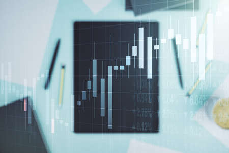 Multi exposure of abstract creative financial chart and digital tablet on background, top view, research and analytics conceptの写真素材