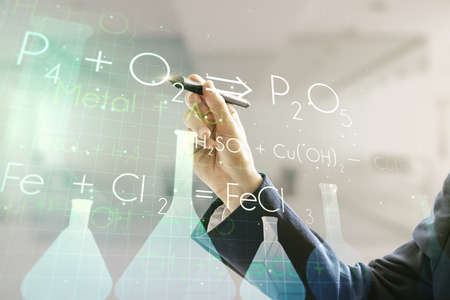 Man hand with pen working with abstract virtual chemistry illustration on blurred office background, science and research concept. Multiexposureの写真素材