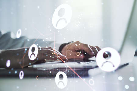 Double exposure of social network icons concept with hand typing on computer keyboard on background. Networking conceptの写真素材