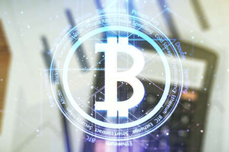 Virtual Bitcoin hologram on calculator background.の写真素材
