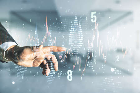 Man hand presses on abstract virtual financial graph on blurred office background, financial and trading concept. Multi-exposureの写真素材