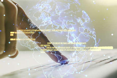 Multi exposure of abstract software development hologram with world map and hands typing on computer keyboard on background, global research and analytics conceptの写真素材