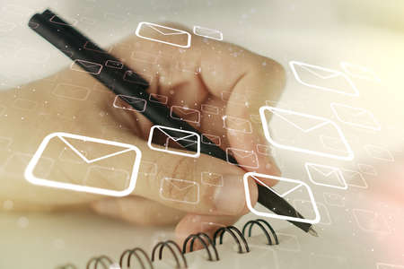 Creative abstract postal envelopes sketch with hand writing in notepad on background, e-mail and marketing concept. Double exposureの写真素材